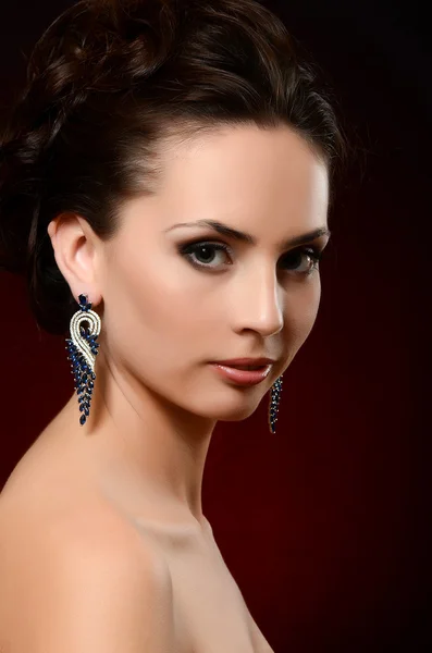 Woman in jewelry earrings — Stock Photo, Image