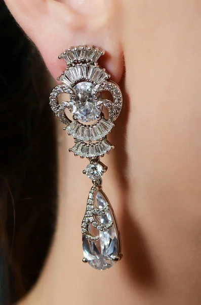 Female ear  in jewelry earrings — Stock Photo, Image