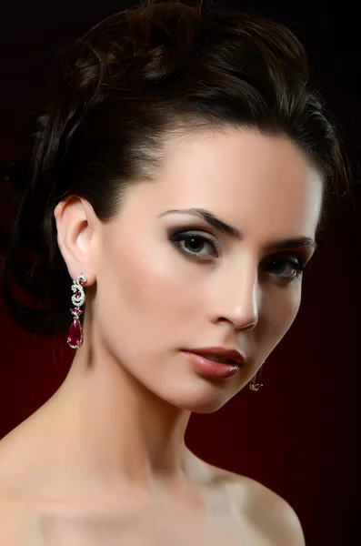 Woman in jewelry earrings — Stock Photo, Image