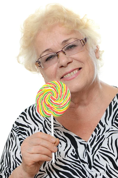 Elderly woman with candy — Stock Photo, Image