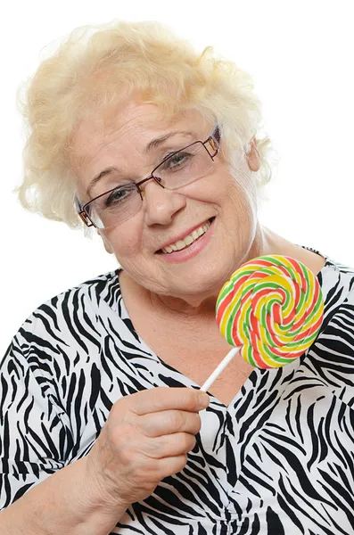 Elderly woman with candy — Stock Photo, Image