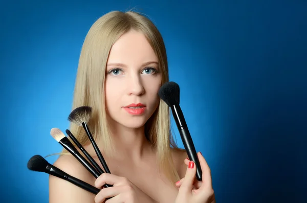 Beautiful girl with brushes — Stock Photo, Image