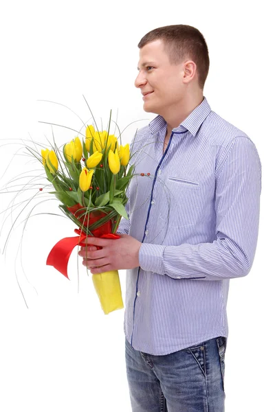 Mladý muž s kyticí tulipánů — Stock fotografie