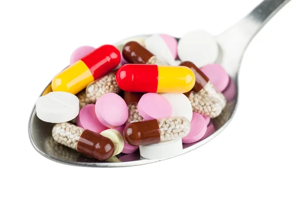 Pills in spoon — Stock Photo, Image