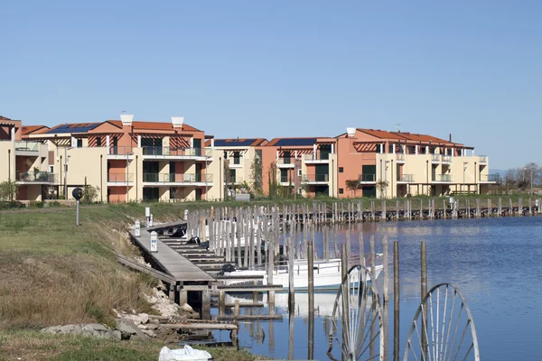 Colored houses with pier near the water — Stock Photo, Image