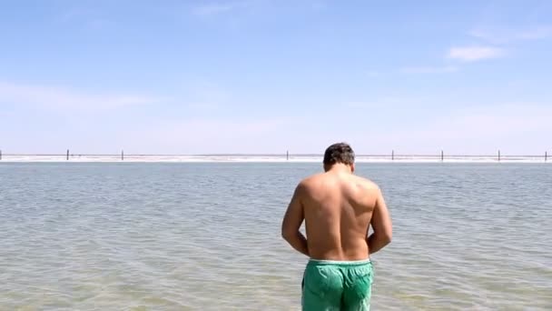 Salt Lake Baskunchak, Russia. May 11, 2013. Man swimming — Stock Video