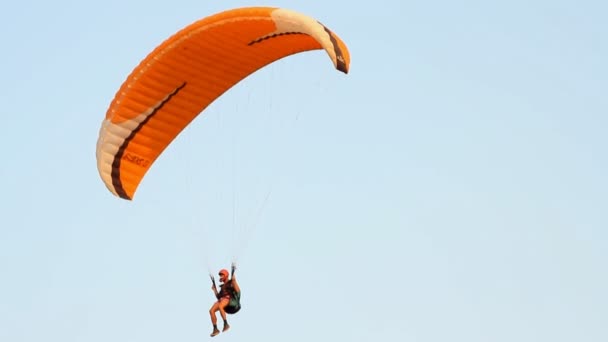 Paragliding over the mountains against clear blue sky — Stock Video