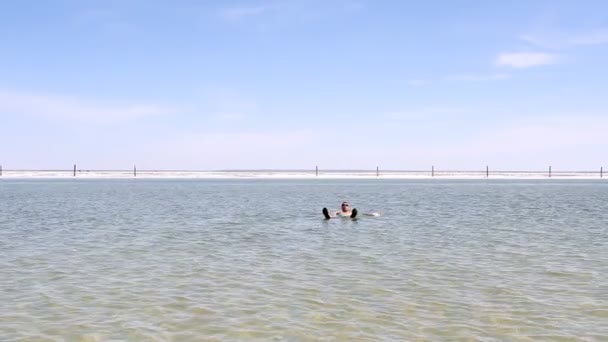Salt Lake Baskunchak, Russia. May 11, 2013. Man swimming — Stock Video