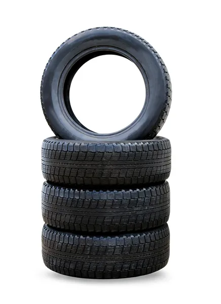 Pila de cuatro ruedas nuevos neumáticos de invierno negro para coche —  Fotos de Stock