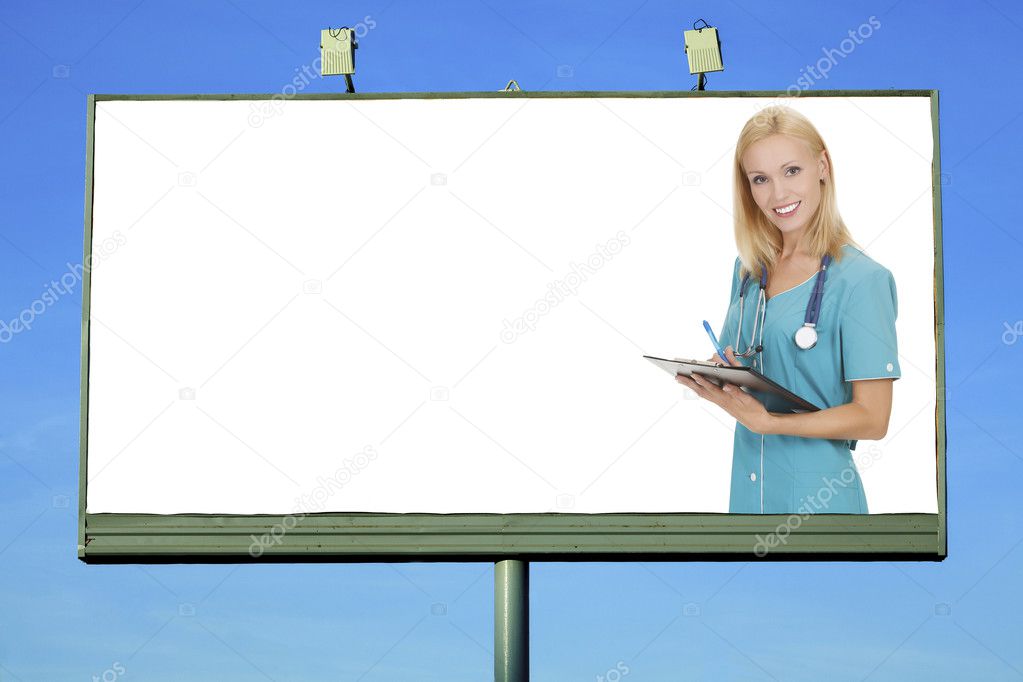 Pretty doctor smiling to you from billboard