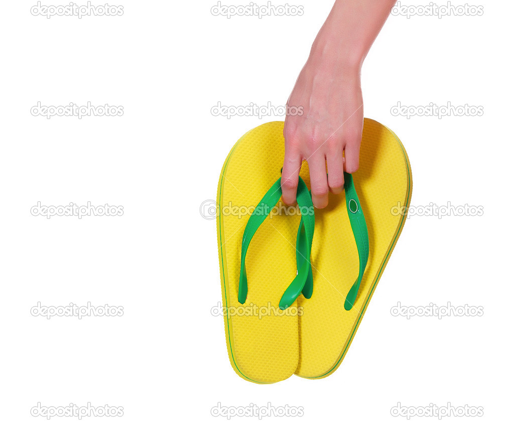 Female hand with yellow flip-flops