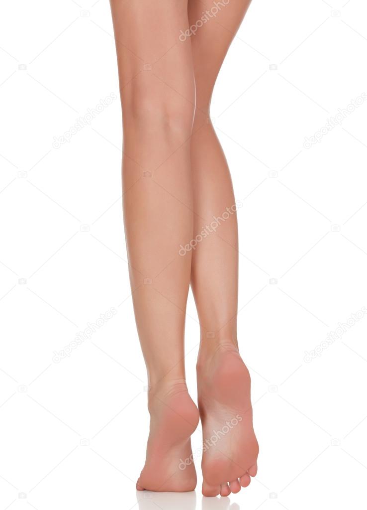 Female legs with pink heels isolated on white background