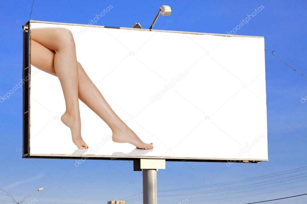 Street billboard with female legs and place for your message