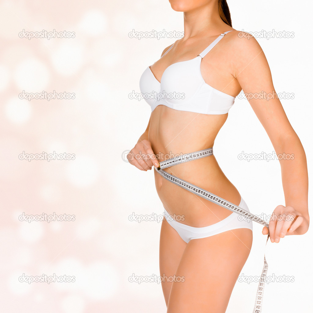 Woman taking measurements of her body