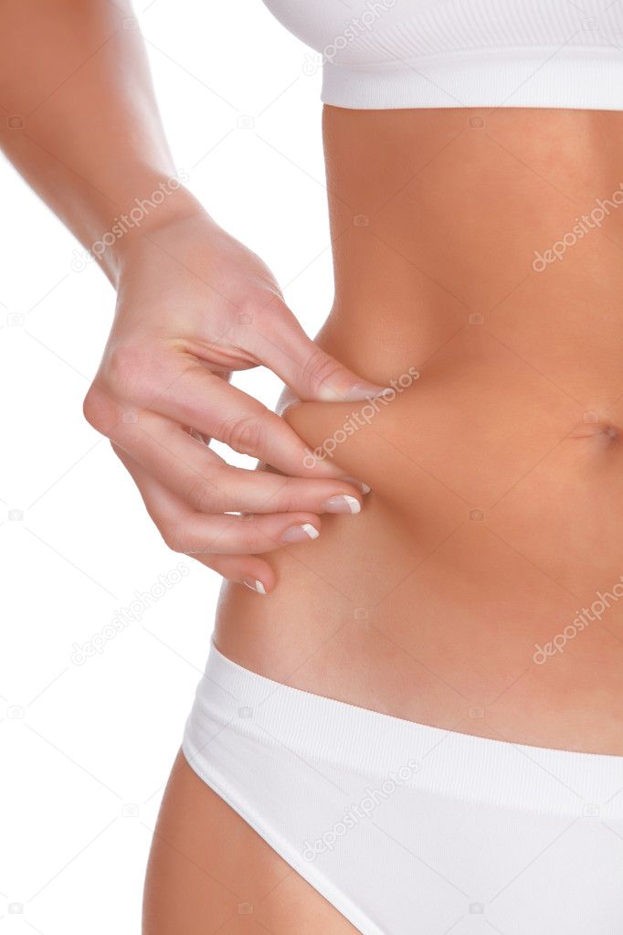 woman pinches fat on the belly, isolated on white