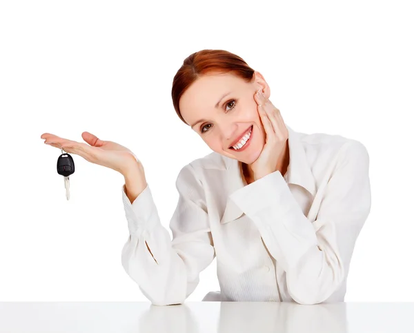 Woman with a key smiling to you — Stock Photo, Image