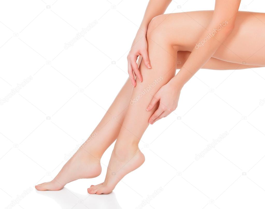 Smooth skin on female legs. White background