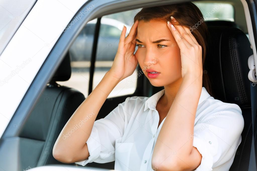 Woman with headache in a car Stock Photo by ©Nobilior 29460689