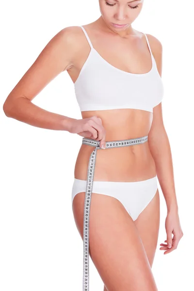 Slim woman in white underwear with tape measure, copyspace Royalty Free Stock Photos