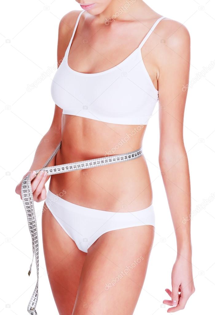Slim woman in white underwear with tape measure, copyspace