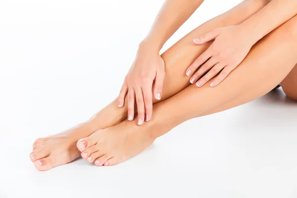 Female legs and hands, white background — Stock Photo, Image