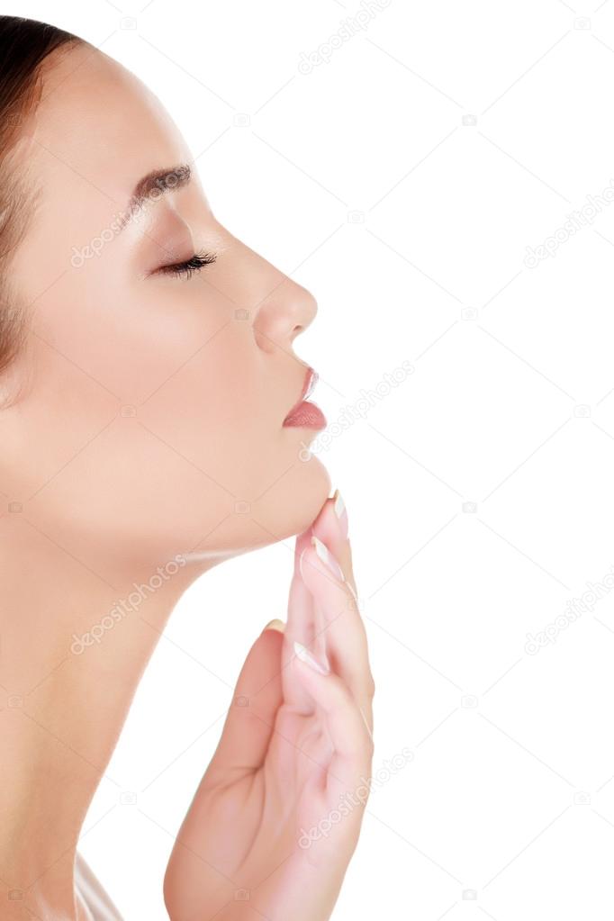 Woman touches her chin, white background