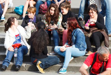 Company of young girls sitting on steps