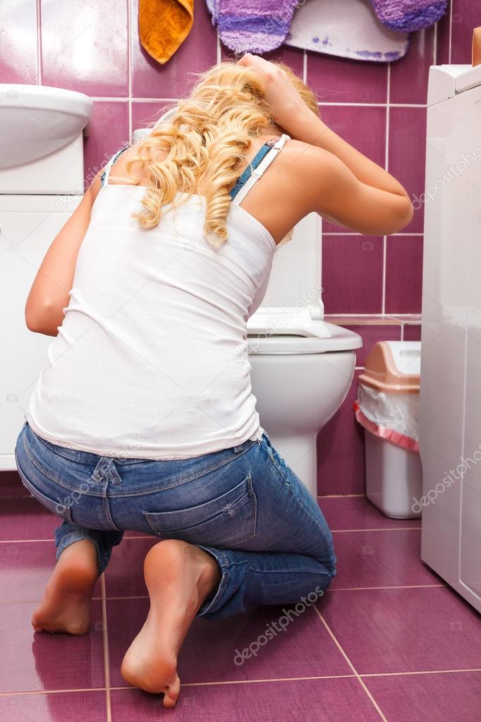 Hangover after party, woman in the toilet
