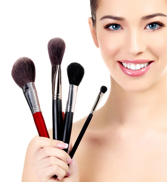 Kvinna med kosmetikborstar, vit bakgrund, copyspace — Stockfoto