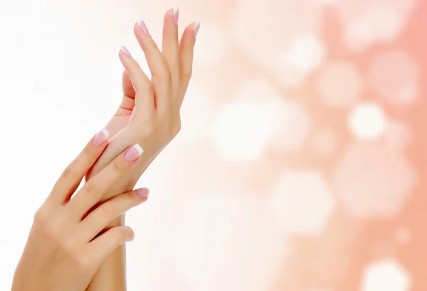 Female hands against an abstract background — Stock Photo, Image