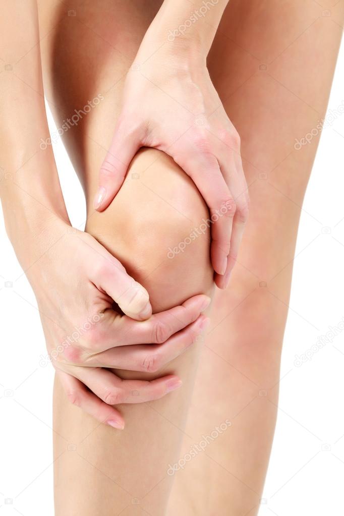 Pain in a leg, woman holding sore knee, white background