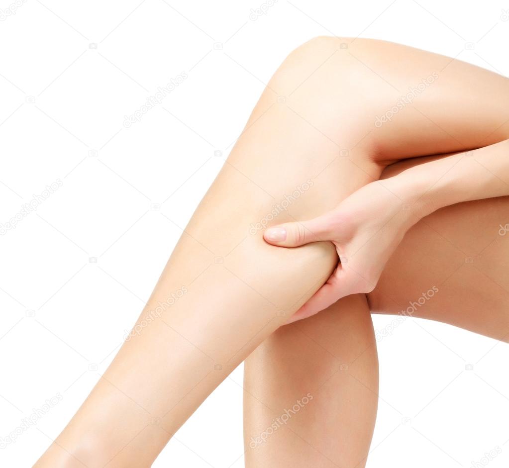 Pain in a leg, woman holding sore shin, white background
