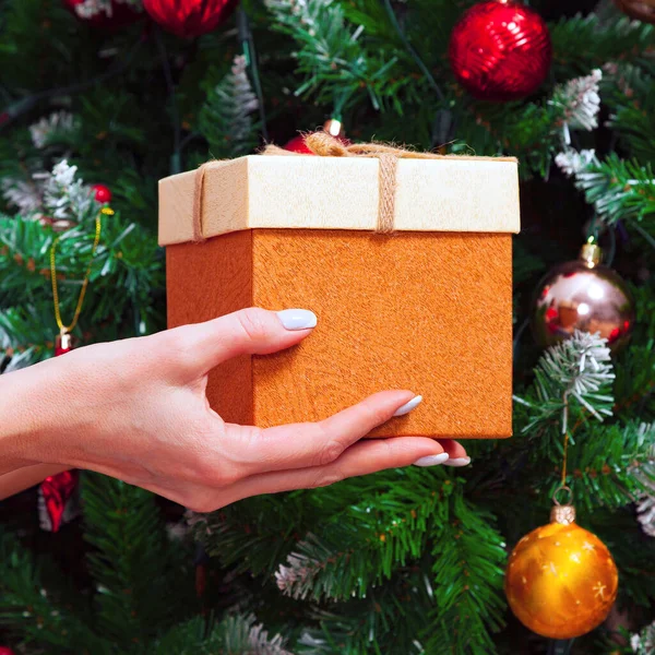 Female Hands Holding Gift Box Decorated Christmas Tree — ストック写真