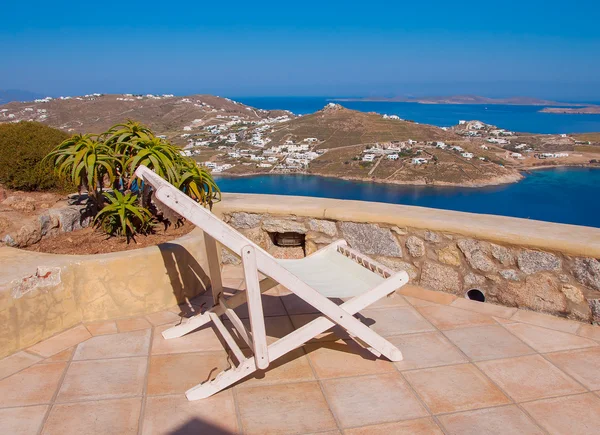 Rocking chair and a table on the background of the sea and islan — Stock Photo, Image