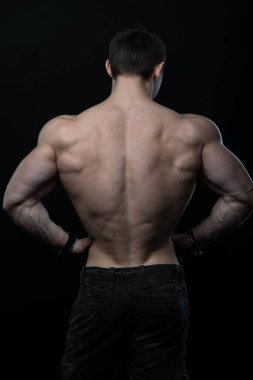 Sırtını gösteren kaslı erkek model.
