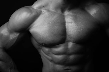 Muscled male chest with water drops