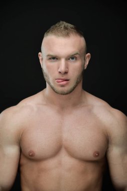 Stüdyoda poz veren kaslı adamın portresi.