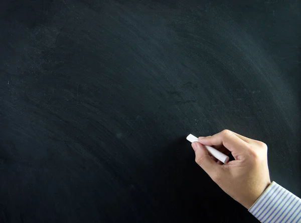 Hand op schoolbord Rechtenvrije Stockafbeeldingen