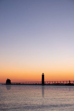 Grand Haven, Michigan 'da gün batımı, Michigan Gölü' nde deniz feneri ve iskele.