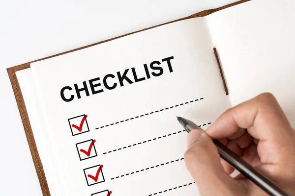 Checklist marked red with a pen on notebook