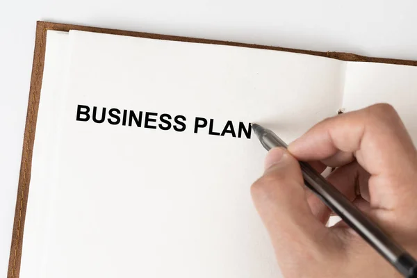 Tekst Biznes Planu Osobą Trzymającą Długopis Notatniku — Zdjęcie stockowe