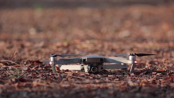 Drone soprando folhas de outono na decolagem — Vídeo de Stock