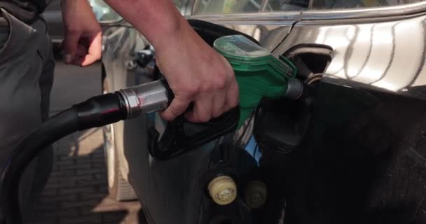 Fuel station nozzle filling car tank — Stock Video