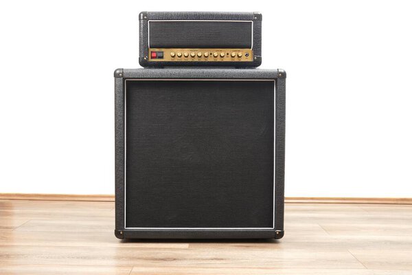 Big guitar amplifier speaker cabinet and tube head, 4x12 rig on the floor