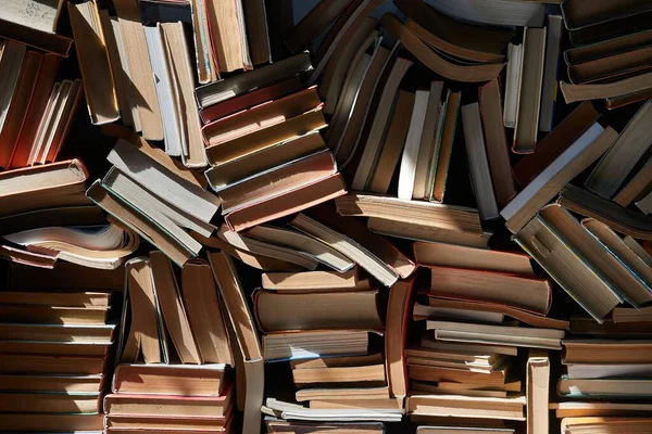 Wall of books piled up — Stock Photo, Image