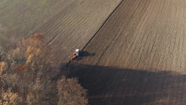 Tractor plowing agricultural soil, drone aerial view — Stock Video