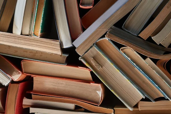 Wall of books piled up — Stock Photo, Image