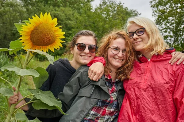 Dívky dělat skupinové fotografie držení slunečnice — Stock fotografie