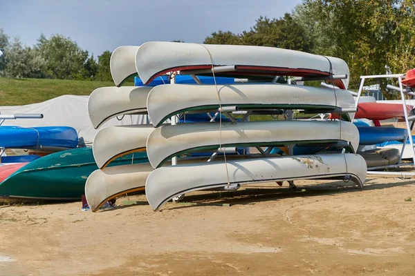 Many canoes and kayaks stored at a renting place