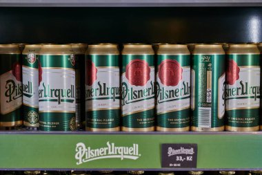 Plen, Czech Republic - Circa 2022: Cans of Pilsner Urquell beer on a shelf in the gift shop of the Pilsner brewery